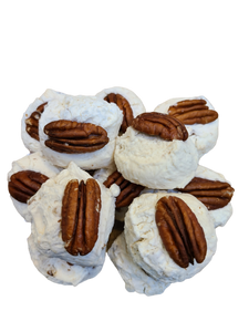 White fluffy nougat topped with a pecan half.