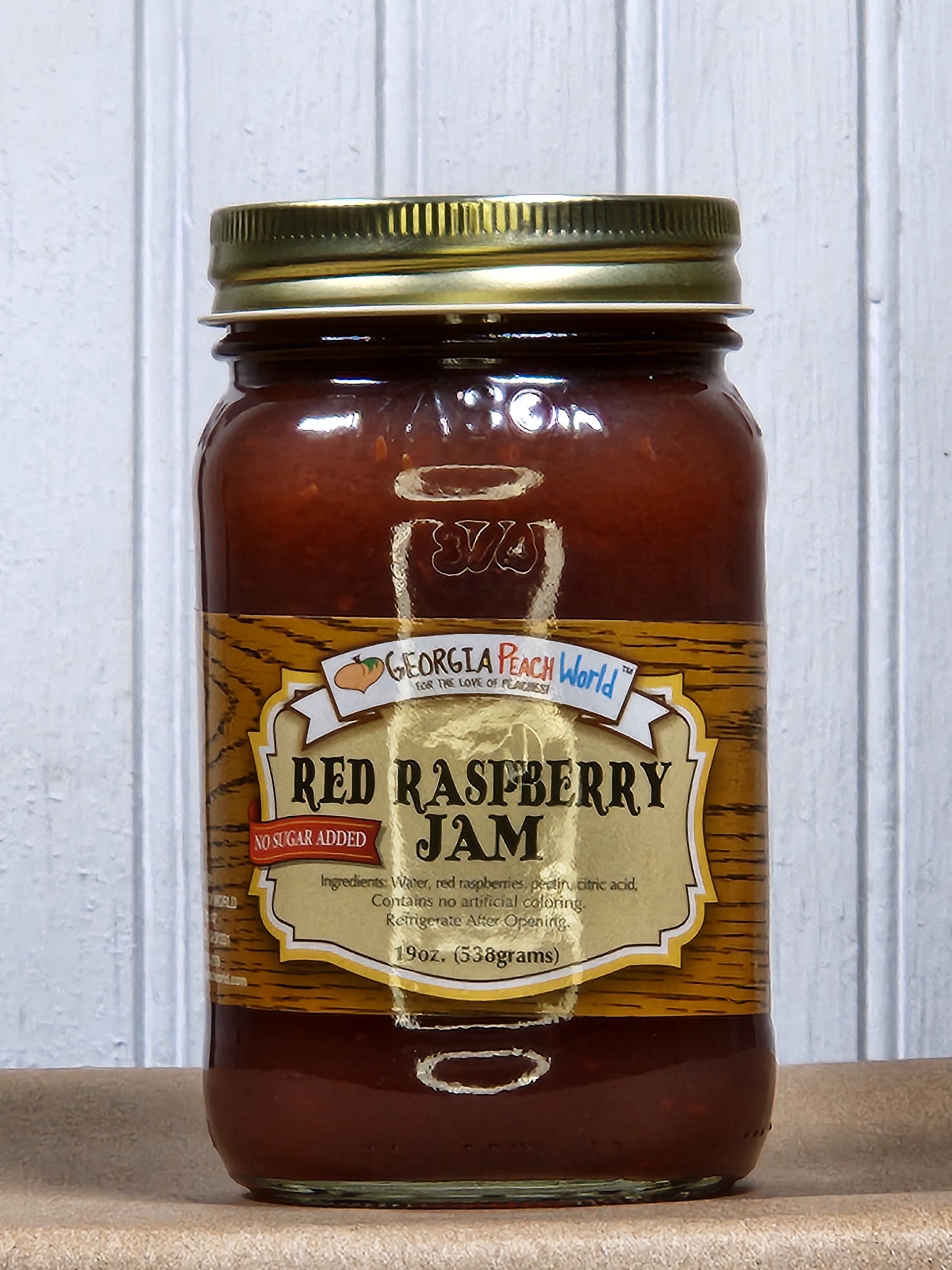 A jar of Red Raspberry Jam with a label indicating it is made with no sugar added and it is a product of Amish country.