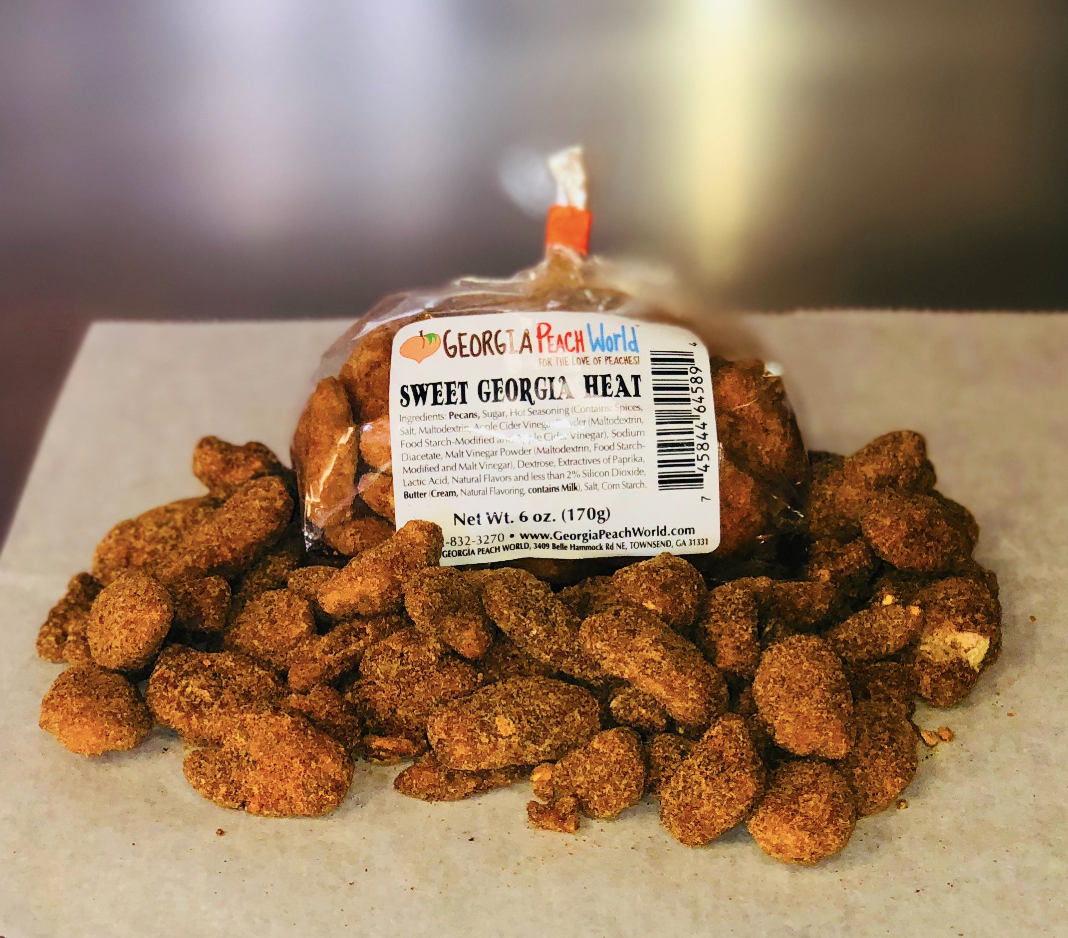 Plastic wrapped pecans covered in cayenne pepper and sugar