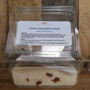 Plastic hinged clam shell package containing a block of peach flavored fudge with dried peaches swirled throughout