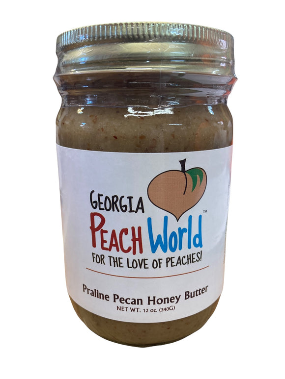 Standard glass mason jar with a shrink wrapped lid containing praline pecan honey spread
