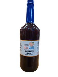 Tall glass quart sized bottle containing blueberry cider