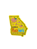 Yellow magnet in the shape of the state of Georgia printed with Georgia Peach World branding and peach shapes throughout