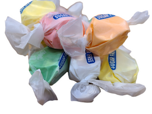 Assorted colored taffy wrapped in wax paper