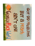 Thin cardstock postcard printed with a blue sky background, grass on the bottom and text that reads "Got 99 problems but a peach ain't one" with Georgia Peach World branding underneath
