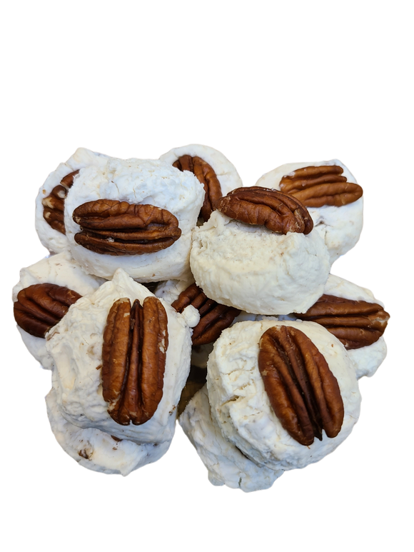 White fluffy nougat topped with a pecan half.